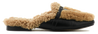 Tan shearling slipper with black sole on a white background